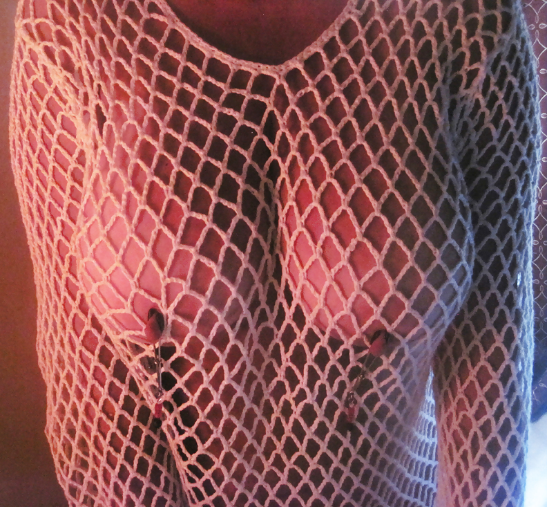 nipple clamps and fishnet top.