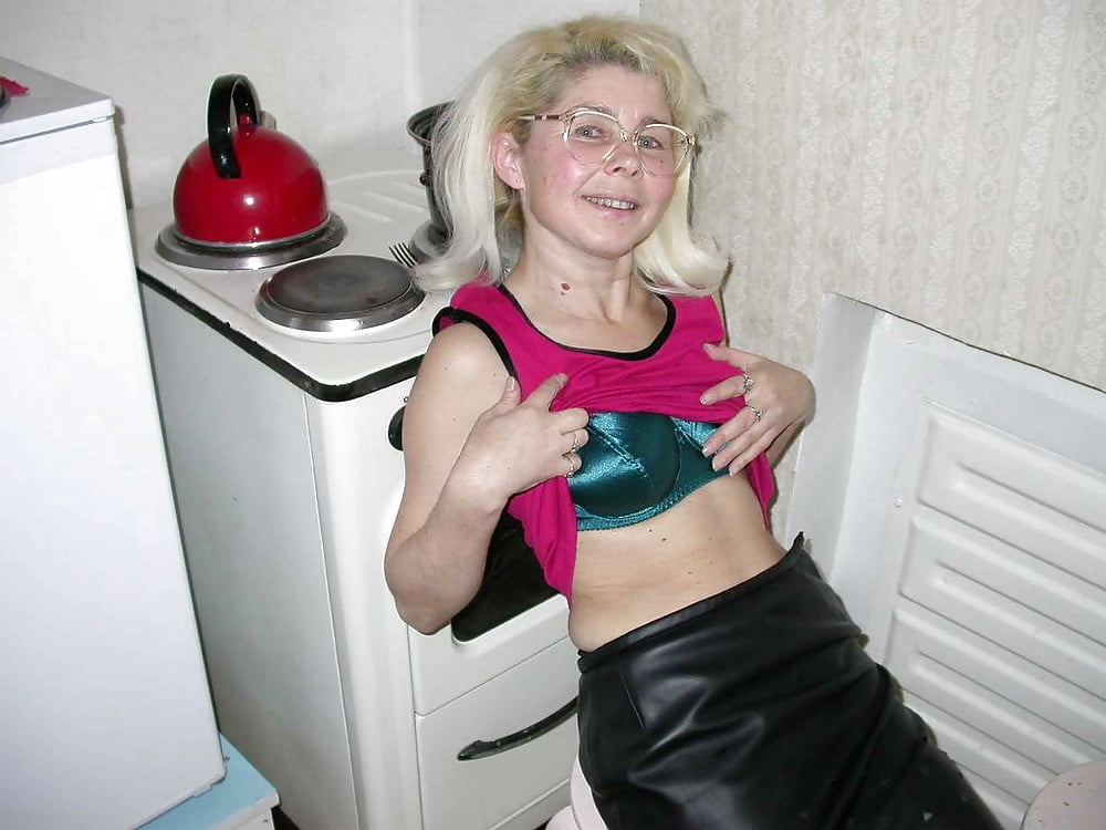 Blonde (?) MILF playing in the kitchen porn gallery